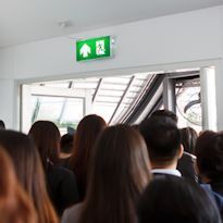 Workers exiting the building through an exit as part of an exercise