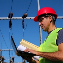 Worker inspecting high power electrical components