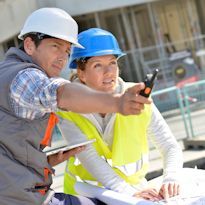 Two workers inspecting construction worksite