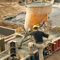 Worker pouring cement