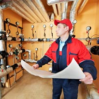 Worker checking schematics for worksite