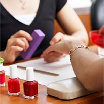 Nail salon worker with customer