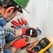 Electrical worker installing outlets