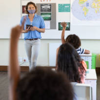 Teacher and student wearing face masks in classroom