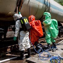 Three HAZWOPER site workers wearing Level A ensemble