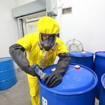 Workers wearing Level B ensembles in field