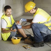 Worker providing first aid to injured worker