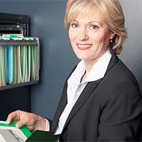 Worker reviewing safety recordkeeping forms