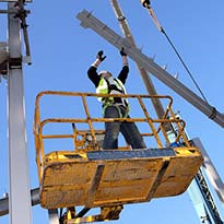 Worker wearing fall arrest protection working in manlift