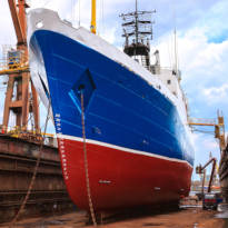 Ship docked along a pier