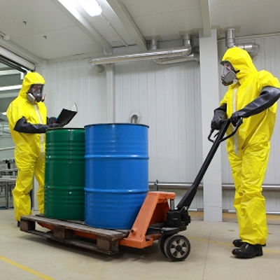 Image of employees moving hazardous chemicals on a cart
