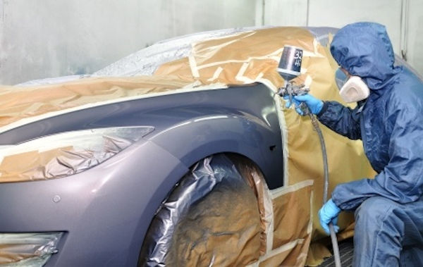 Image showing worker spray painting a vehicle