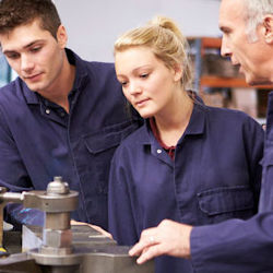 Image of an instructor and two students conducting on the job training.