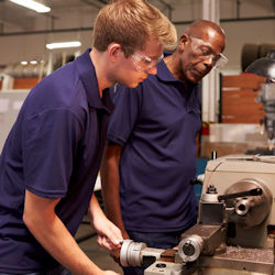 Image of a trainer observing an employees skills.