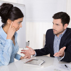 Image showing two employees in discussion about performance.