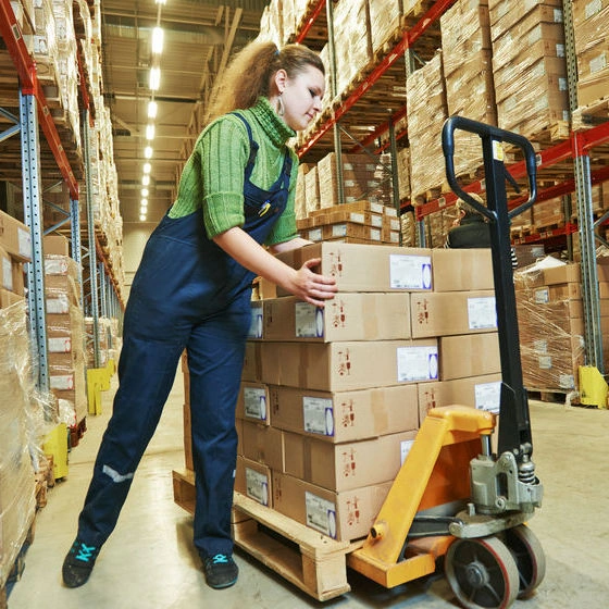 Worker lifting and twisting while lifting boxes.