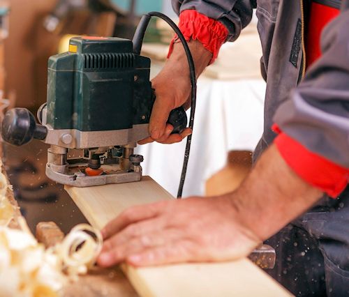 Worker focused on using sander