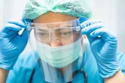 healthcare worker wearing full ppe including a face shield