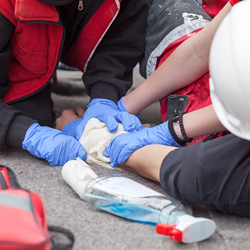 Image of Gloved Hands Giving First Aid to Patient