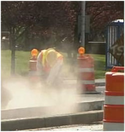 Worker cutting concrete