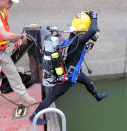 USACE diver entering water with another worker standing by