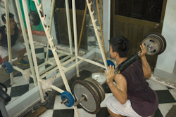 student lifting weights unsupervised