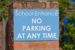 School sign showing no parking at any time
