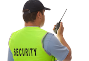 Security guard speaking on a walkie-talkie.