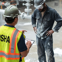 OSHA inspector citing a worker for not wearing PPE. 