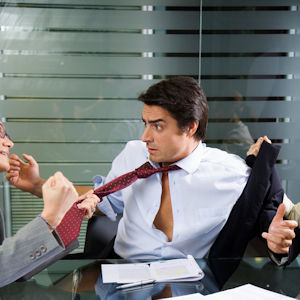 Two workers in a meeting one is pulling on the tie of the other being assaulted.