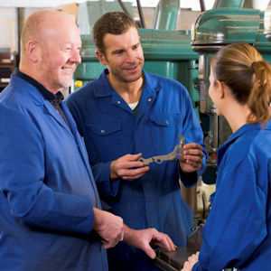 Three mechanics talking to each other.