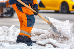 Worker shoveling snow.