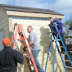 Two people each climbing a different type of ladder.
