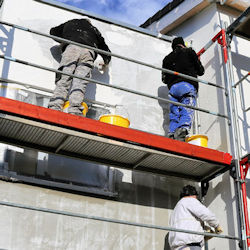 Two workers on scaffold platform
