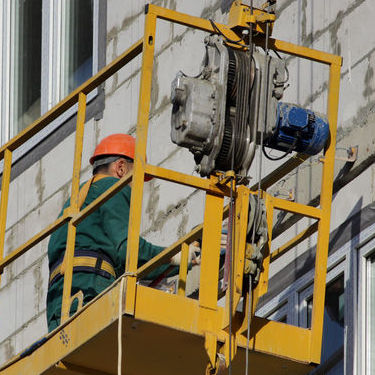 Worker on scissor lift platform
