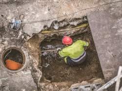 One worker descending into a Sewer Confined Space