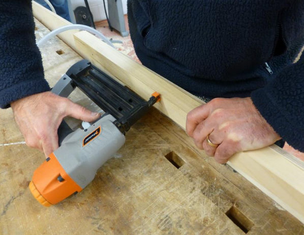 Contains public sector information published by the Health and Safety Executive and licensed under the UK Open Government Licence Worker using nail gun but the nail point is pointed towards his body.
