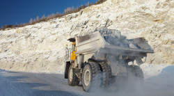 Dump truck traveling down desolate road