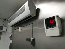 Industrial restaurant sized freezer door and digital thermometer.