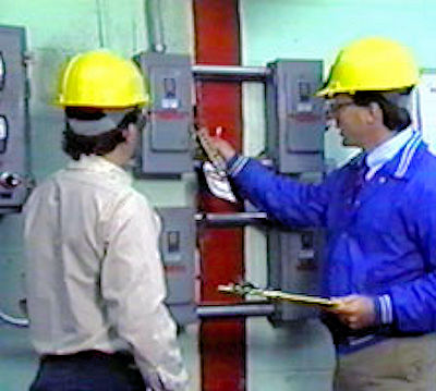 Two employees performing lockout/tagout inspections.