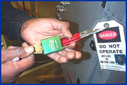 Worker unlocking a lockout device.
