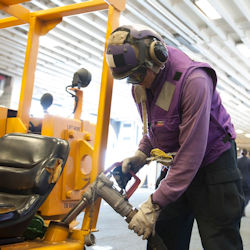 Worker refueling forklift