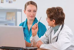 Nurse training employee sitting in front of laptop