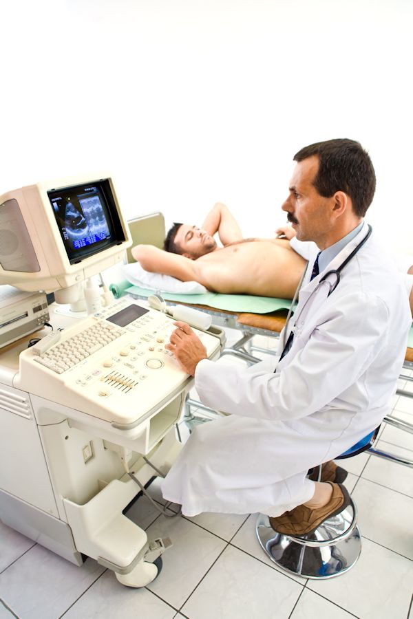 Doctor performing a sonogram on a patient.