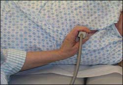 Ultrasound tech conducting ultrasound with poor wrist ergonomic technique.
