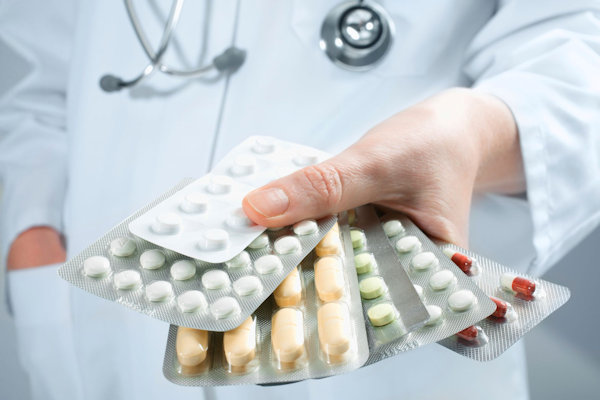 Pharmacist holding a handful of hazardous drugs