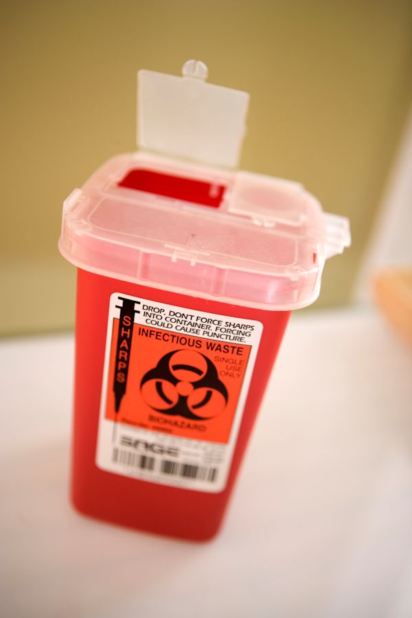 SHARPS container with an open lid.