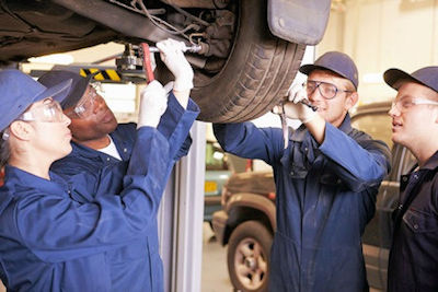Image of workers participatinig in on the job training for vehicle maintenance