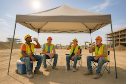 Worker in PPE standing near a radiant heat barrier