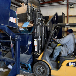 Forklift and driver in a recycling facility.